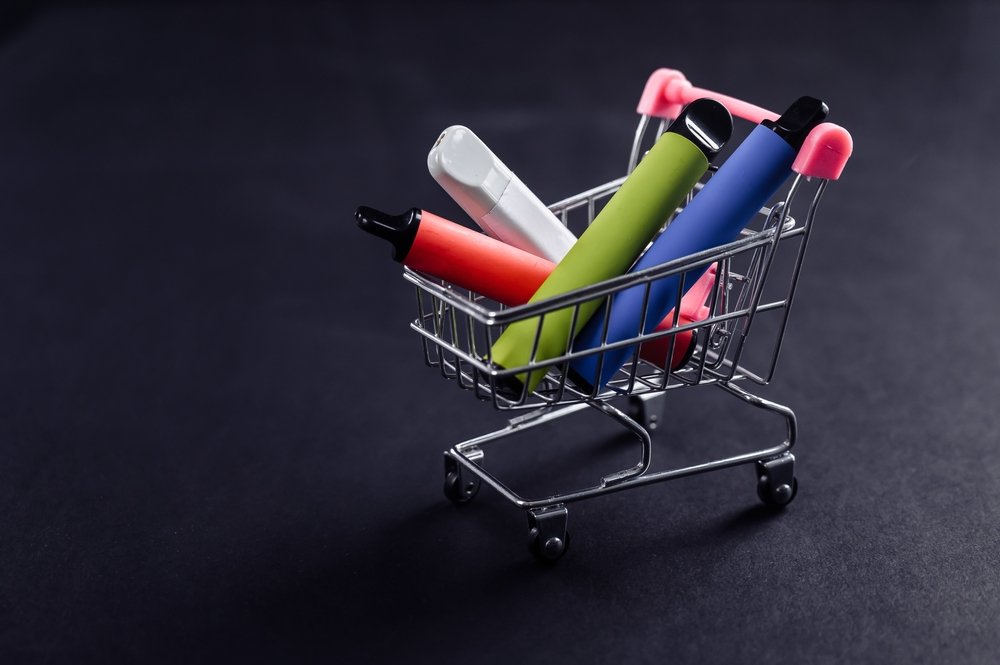 Disposable Vapes In A Shopping Cart On A Black Background